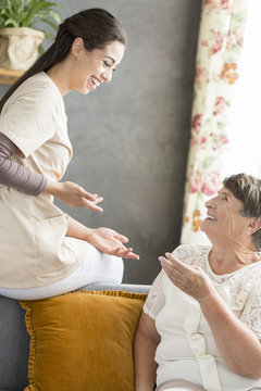 Senior woman conversating with caregiver