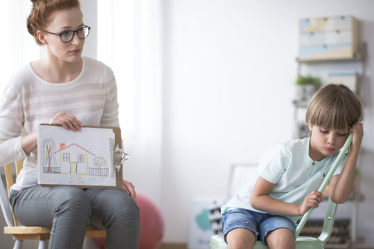 Psychotherapist showing picture to boy