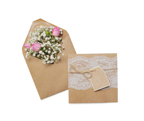 Mockup kraft envelope full of various flowers rose wiht tag. Flat lay. Love concept isolated clipping mask on white background with path, top view
