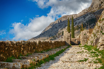 Old fortress and mountains against the blue sky