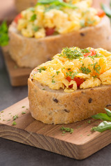 Tasty sandwich with egg and vegetables on old wood block background

