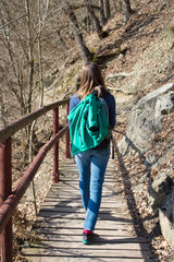 Girl hiking in spring or autumn weather throught rough trail