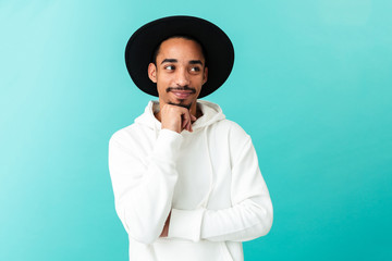 Portrait of a smiling young afro american man in hat