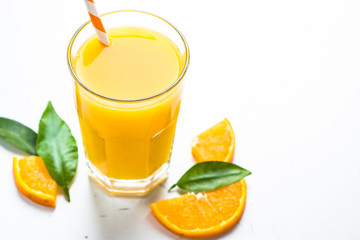 Orange juice in glass on white.