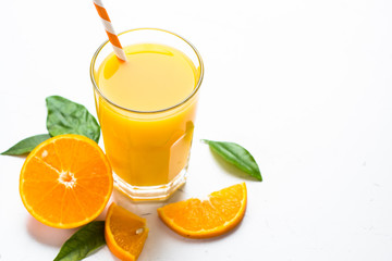 Orange juice in glass on white.