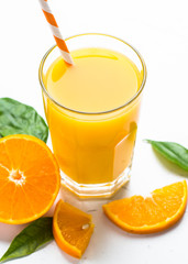 Orange juice in glass on white.