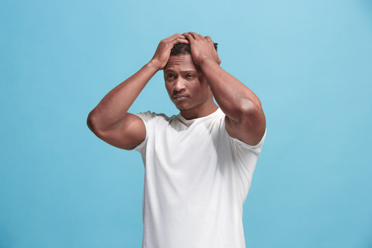 African American Man having headache. Isolated over blue background.
