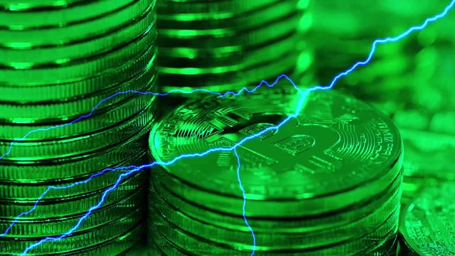 Blockchain technology, Bitcoins mining concept in green light with lightning, macro shot of bitcoins. Cryptocurrency Bitcoin, BTC, coins rotates in green light, power consumption concept