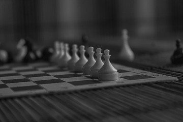 Monochrome Wooden Chess Board and steel chess pieces, isolated on board