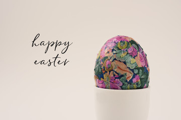 homemade decorated easter egg in an egg-cup