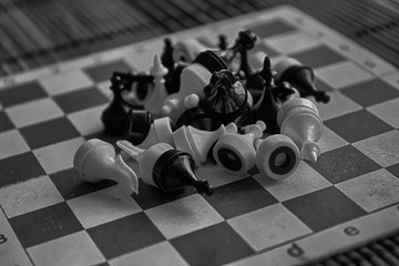 Monochrome Wooden chess Board and magnetic plastic chess pieces, on board
