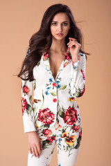 Beautiful fashionable woman well dressed, handbag and accessories. Fashion spring summer photo. Flower pattern