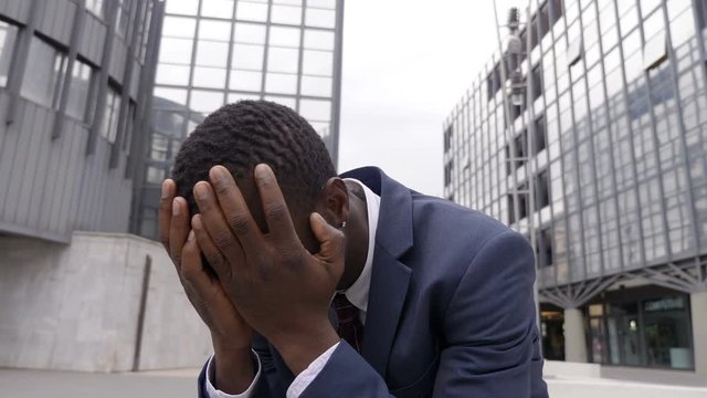 failure at work, dismissal, despair- Desperate sad fired black businessman