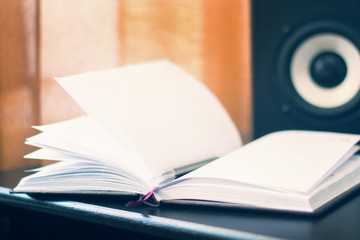 work place with notebook or book on surround sound column background