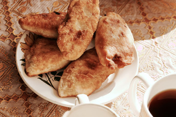 home cooking. meat pies on the table lit by the sun.