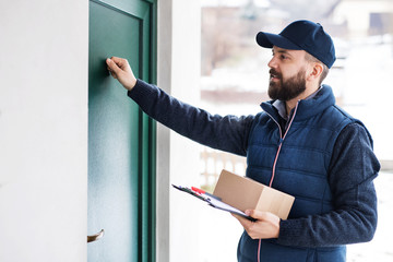 Delivery man delivering parcel box to recipient.