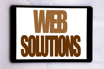 Hand writing text caption inspiration showing Web Solutions. Business concept for Internet Design Plan written on tablet screen on the white background.