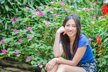Beautiful Asian girl standing behind the bamboo