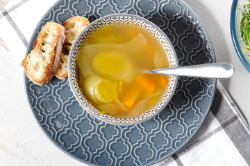 bowl of soup of vegetables on blue plate