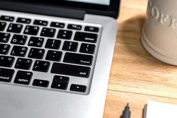Laptop ,notebook ,pen and coffee on wood table, travel keyword