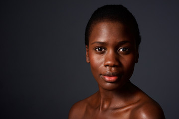 Fototapeta premium Close up beautiful african woman looking at camera with naked shoulders