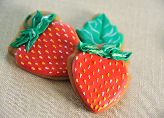 Two gingerbreads in the form of red strawberries. Close-up
