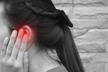 Tinnitus, young woman has pain in the ear