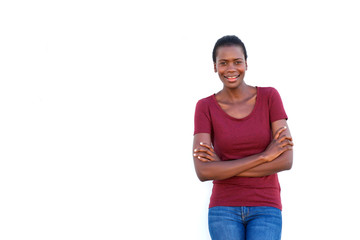 smiling young black woman standing with arms crossed on white background