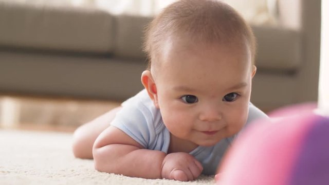 sweet little asian baby boy playing with toy