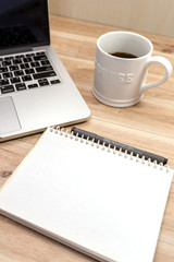 Laptop ,notebook ,pen and coffee on wood table