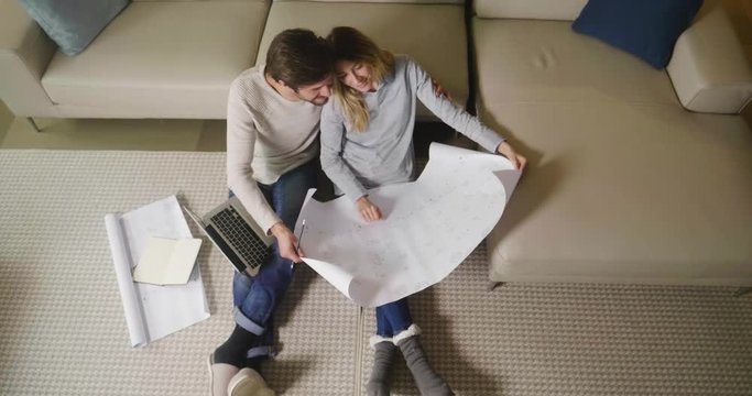 Portrait of a couple in love who is planning new home and furniture. The two couples smile and are happy with the futuristic project together. Concept of: future, family, design and projects.