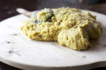 steaming polenta on a wooden plate