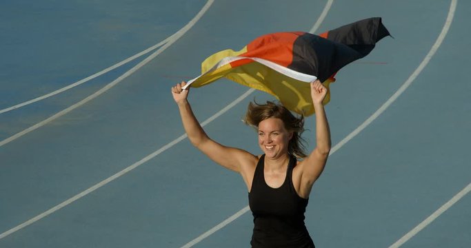 A German Athlete Flying the National Flag of Germany.
