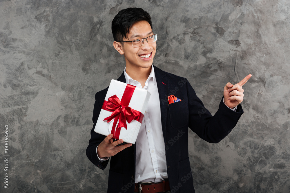 Canvas Prints Portrait of a smiling young asian man dressed in suit