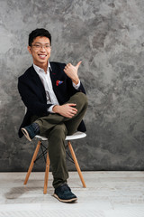 Full length portrait of a satisfied young asian man