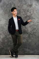 Full length portrait of a happy young asian man
