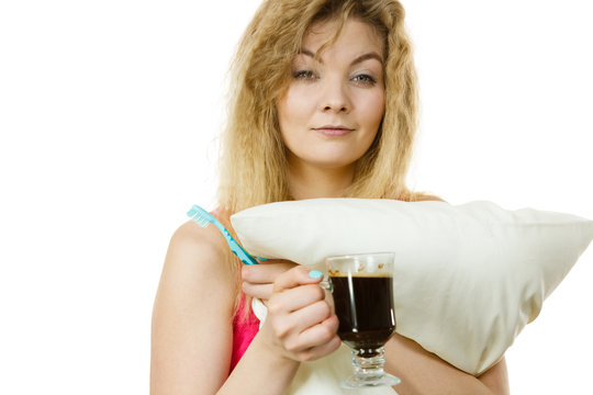 Happy woman holding toothbrush and coffee