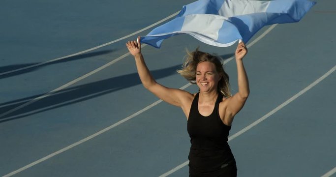 An Argentinian Athlete celebrates with the National Flag of Argentina.