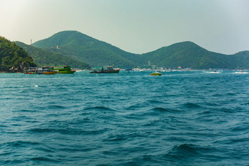 boats on sea and mountain on island. sea in thailand is one popular location of traveller in summer.