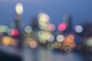 Defocused image, raindrop on glass window of building, colorful bokeh with ho chi minh city on background