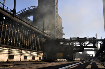 Manufacture of coke in a coke oven battery. In the front zone. Coke-pusher Avdeevka 2017.