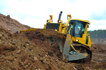 Bulldozer operation in the ore quarry. Daylighting