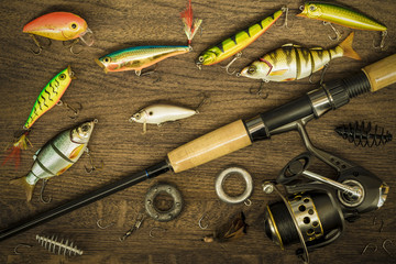 Fishing tackle on wooden background.