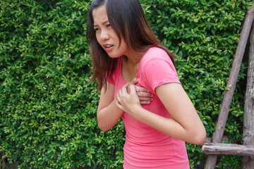 Fototapeta premium Sporty woman having heart attack - Angina Pectoris, Myocardial Infarction.