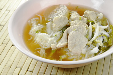 boiled rice noodles topping slice pork and ball in clear soup