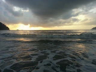 Dark clouds over a beautiful tropical beach with palm trees on Tioman island in Malaysia