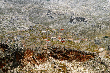 View of the ancient Pothia, with the remains of the castle of Chora or Grand Castle of Paleochora (built in 1495) in the background. Kalymnos island, Dodecanese islands, Greece.