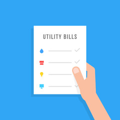 hand holding sheet with utility bills