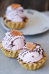 Delicious cakes with berry cream and chocolate sauce