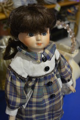 Bright expressive ceramic brunette doll in bright clothes